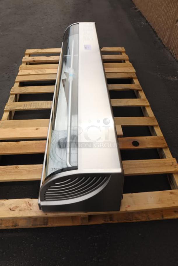 Brand new Hoshizaki HNC-180BA-L-SLH 71" curved glass sushi display case with left side compressor on a pallet.