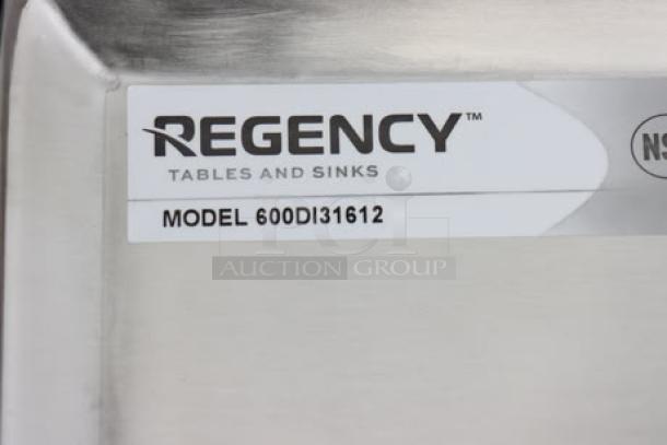 Regency 600DI31612 label on stainless steel three-compartment sink. Packaging lightly damaged, possible minor scratches/dents.