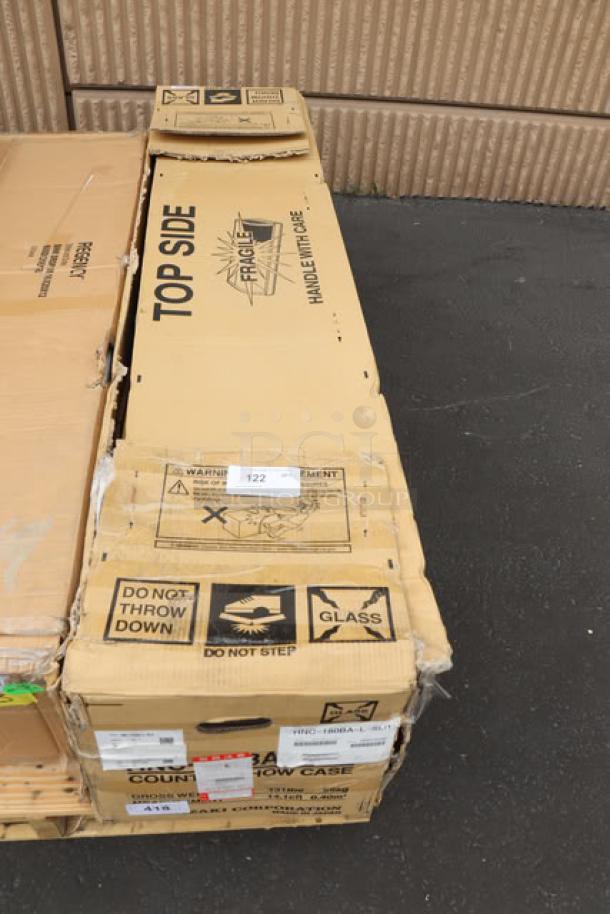 Boxed Hoshizaki HNC-180BA-L-SLH sushi display case, 71", left side compressor. Glass broken. Packaging shows handling warnings.