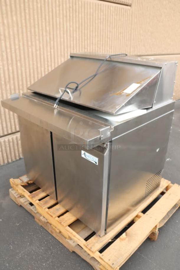 Brand new Avantco SS-PT-36M-HC 36" 2-door stainless steel refrigerated sandwich prep table on pallet. Minor scratches/dents visible.