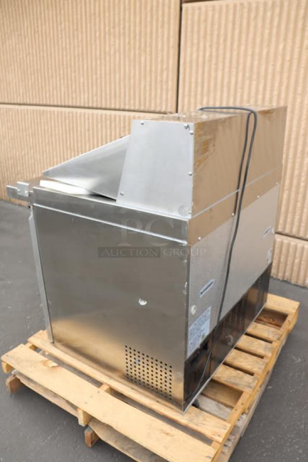 Brand new Avantco SS-PT-36M-HC 36" 2-door stainless steel refrigerated prep table, slight scratching/denting, on pallet.