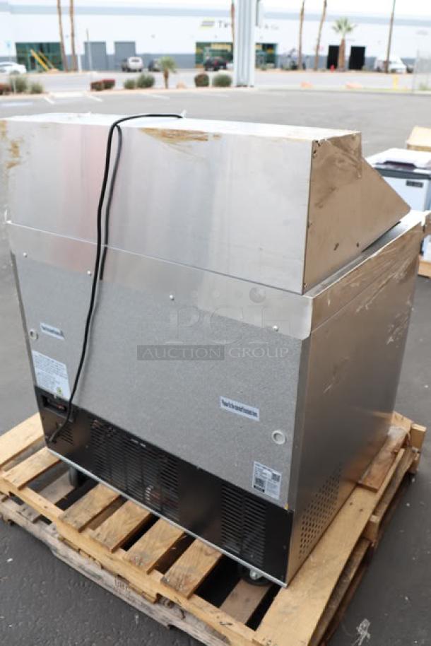 Brand new Avantco SS-PT-36M-HC, 36" 2-door stainless steel sandwich prep table with minor scratching/denting, on a pallet.