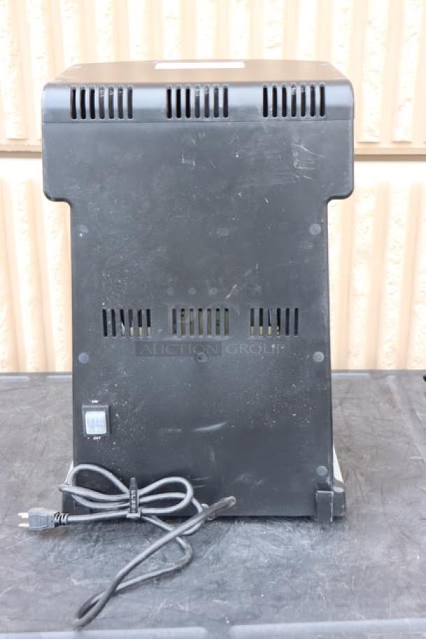 Back view of Waring WDM360TX Triple Spindle Drink Mixer, showing power cord and on/off switch, in used condition.