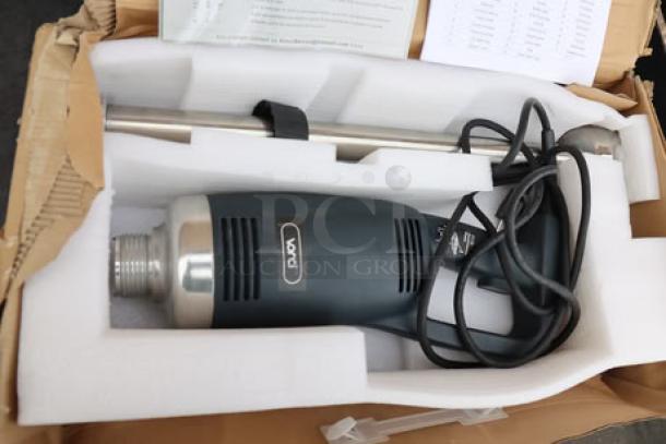 Vonci Immersion Blender in open box, sleek design, appears unused. Includes power cord and manual, neatly packaged in foam.