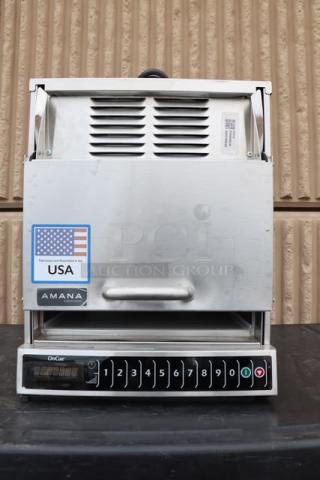 Brand new Amana AOC24 commercial microwave, 2400W, 208/240V, shows USA marking, serial number 2506180055, slight scratches.