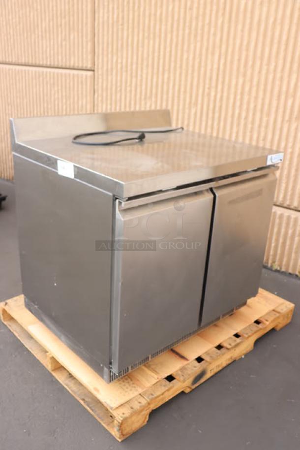 Brand new Avantco ZWT-36R-HC 36" worktop refrigerator with minor dents, 3 1/2" backsplash, on a wooden pallet.