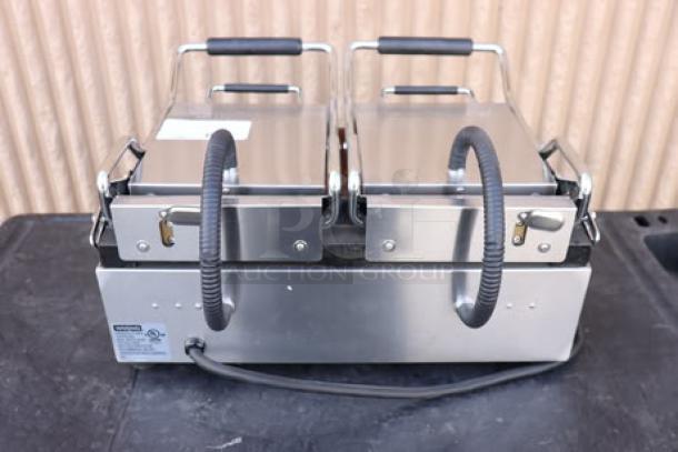 Brand new Waring WFG300 dual panini grill with smooth top & bottom plates, 17"x9.25" surface, model label visible, 240V, 3120W.