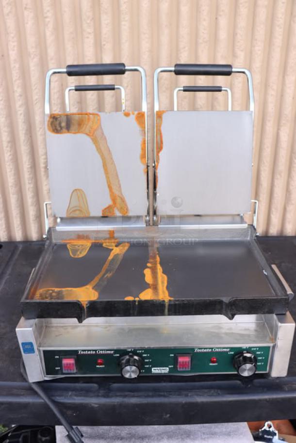 BRAND NEW Waring WFG300 Tostato Ottimo dual panini grill, 17"x9.25" cooking surface, 240V, 3120W, smooth top/bottom plates, with orange residue.