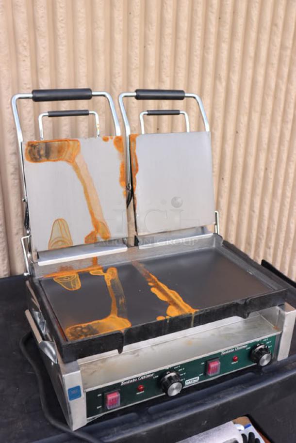 Waring WFG300 dual panini grill, 17" x 9.25" surface, 240V, with visible scratches and stains on plates.