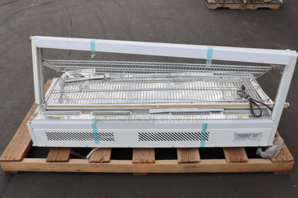 ChocoVision C116USREV2WHI Revolation 2 Chocolate Tempering Machine on palette with heated display, unassembled parts.