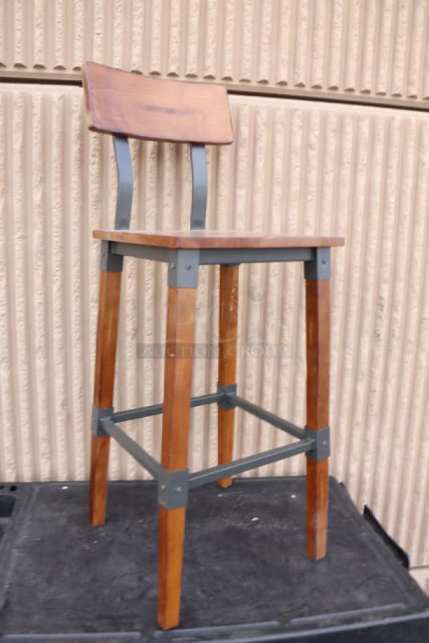 Lancaster Table & Seating industrial bar stool, model 164BINDWALAN, with rustic walnut finish. New condition, no packaging.