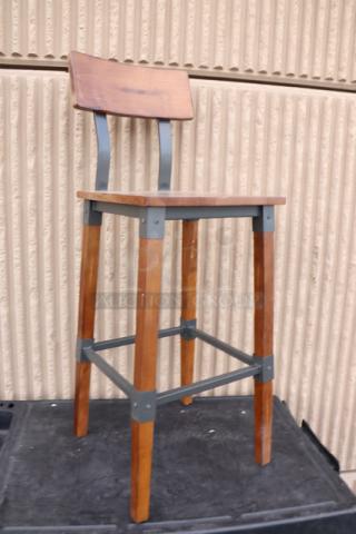 Lancaster Table & Seating industrial bar stool, model 164BINDWALAN, with rustic walnut finish. New condition, no packaging.