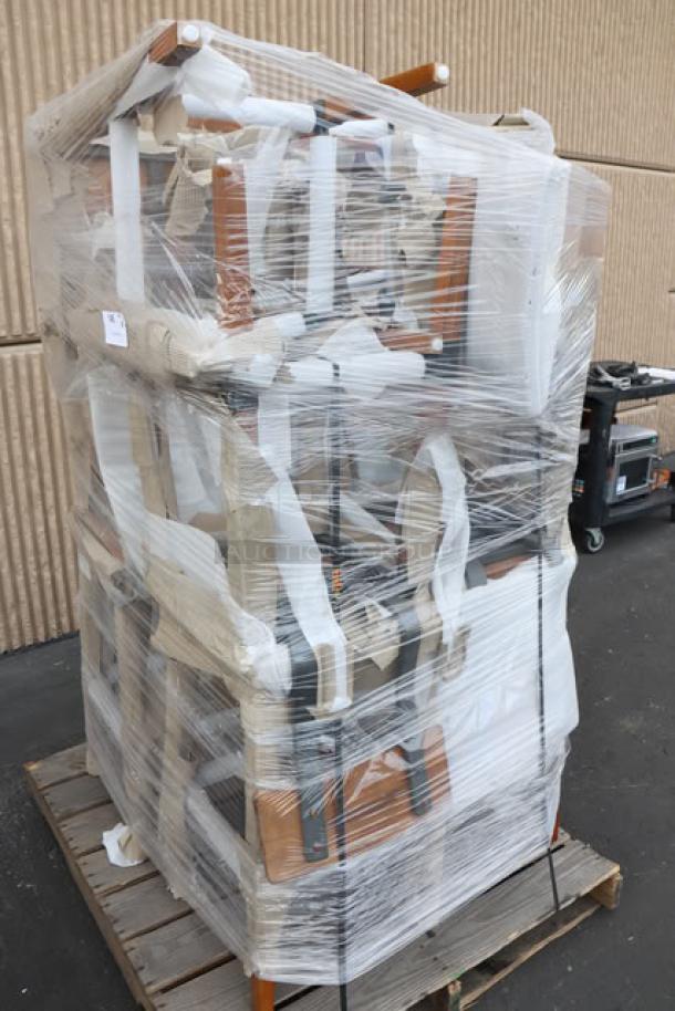 10 new Lancaster Table & Seating industrial bar stools with rustic walnut finish, model 164BINDWALAN, stacked on a pallet.