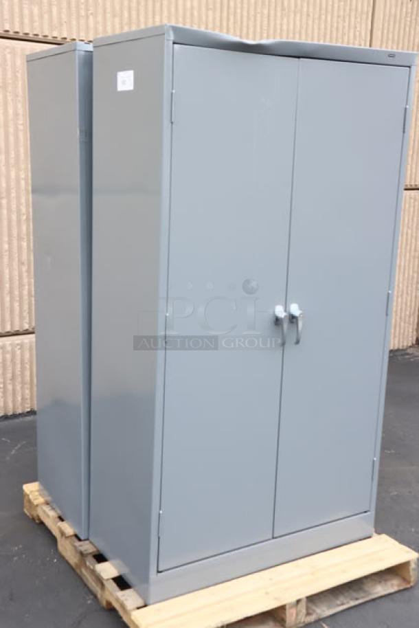 Brand new Tennsco 6618DH-MGY dark gray storage cabinet, 18"x36"x66", solid doors, minor scratches, on pallet.