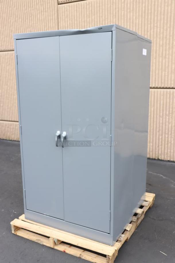 Tennsco 18"x36"x66" dark gray storage cabinet, model 6618DH-MGY, solid doors, scratch-n-dent condition, on pallet.