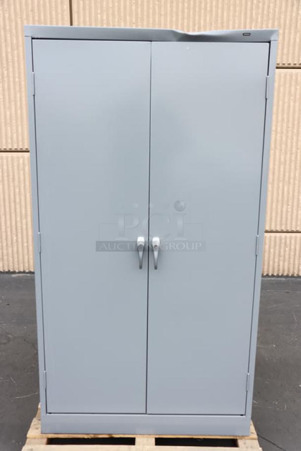 Tennsco 18"x36"x66" dark gray storage cabinet, model 6618DH-MGY, solid doors, minor top dent, assembled condition.