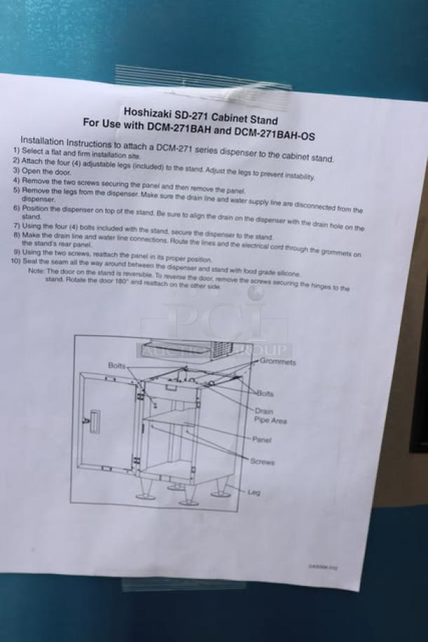 BRAND NEW Hoshizaki SD-271 ice machine stand with lockable door, minor scratches and dents, S/N: Q54112E. Installation guide visible.