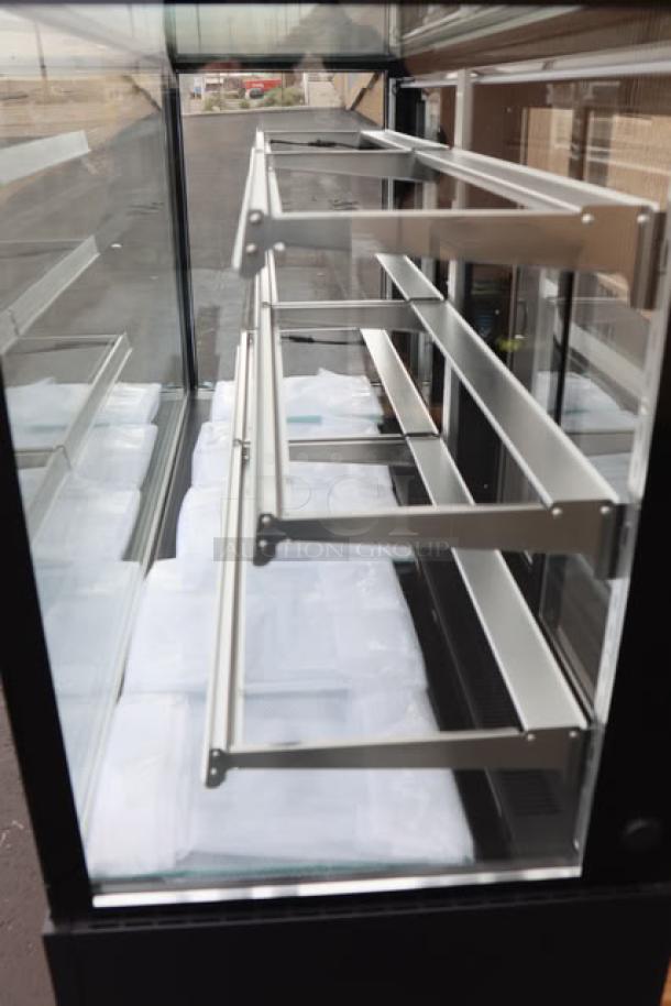 Brand new Avantco BCF-72-HC refrigerated bakery display case, 70 7/8" square glass, black finish, three shelves, 115 volts, 8.5 amps, 1 phase.
