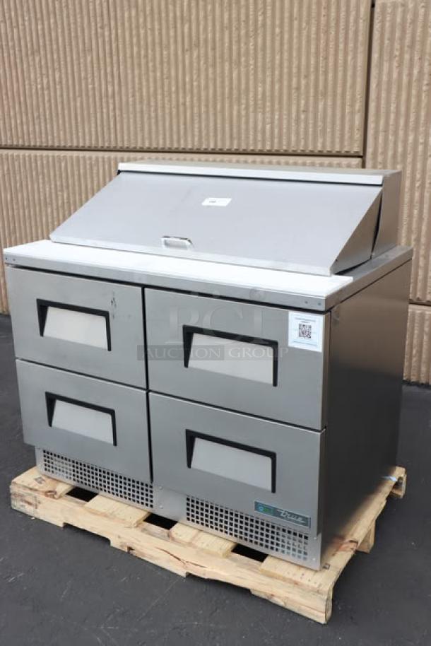 Brand new True TFP-48-18M-D-4-HC sandwich prep table, four drawers, minor scratches, model plate visible.