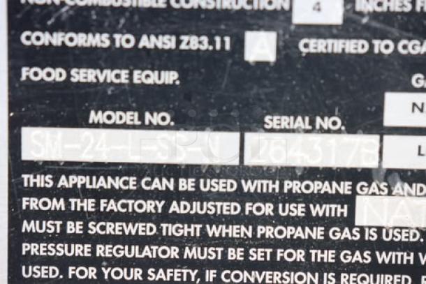 Town SM-24-L-SS Smokehouse label with model and serial number 2643178, indicating natural gas use and safety instructions.
