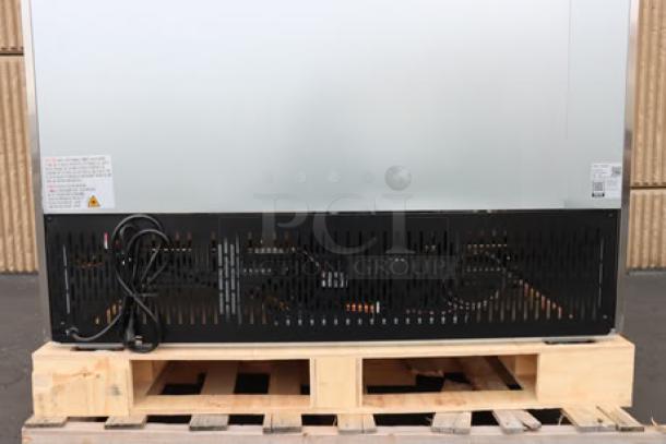 Brand new Avantco A-49F-HC 54" solid door reach-in freezer, 115V, 8.5A, 1 phase, 780W, shown on a pallet without packaging.