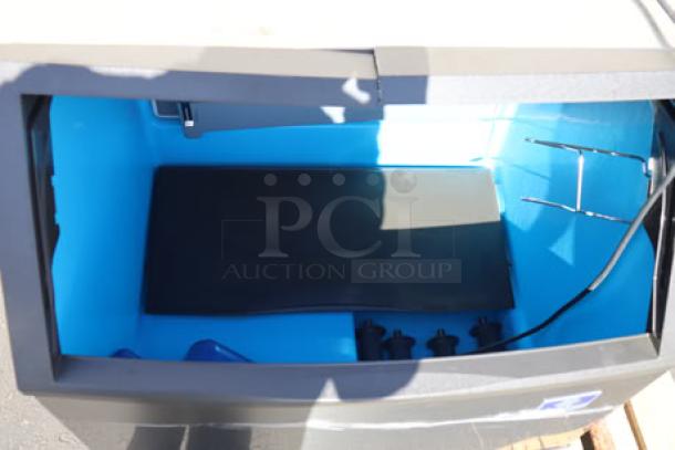 Manitowoc UDF0310A ice machine interior with 119 lb. bin, new condition, serial number 310682759 visible.