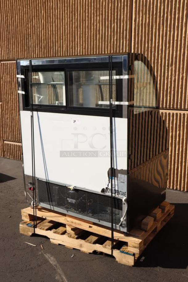 Avantco CAC-48 refrigerated air curtain merchandiser on pallet. Top glass shattered; black curved dual service model. 115V, S/N: 1710406200002.