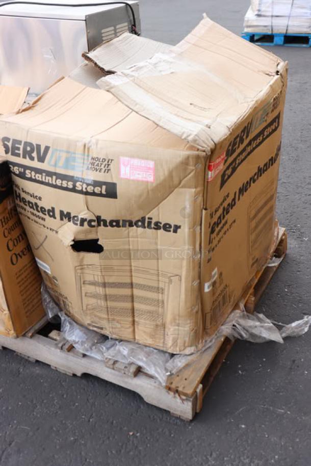 Brand new ServIt HDM-26 26" heated display case in damaged box. Glass intact. Model and details visible on packaging.