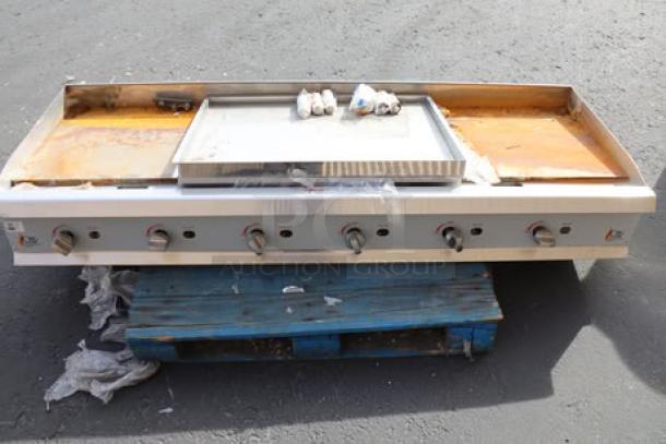 Cooking Performance Group GM-CPG-72-NL gas countertop griddle. Slight wear, six manual controls, on a blue pallet.