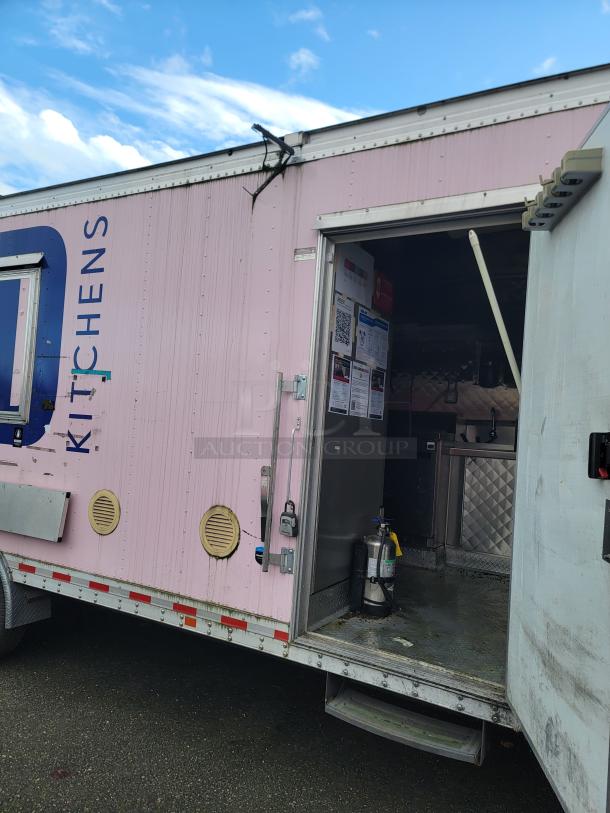 2021 16' REEF/NBRHD mobile kitchen trailer, pink exterior, open door showing interior kitchen setup, visible diamond-plate flooring.
