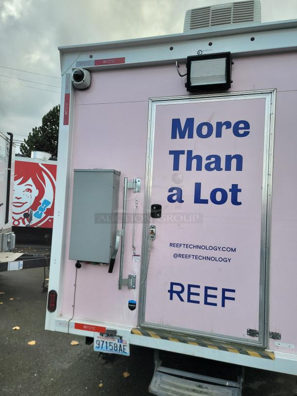 2021 Quality 16' pink mobile kitchen trailer exterior with security camera, Arctic Air refrigeration, and REEF branding.