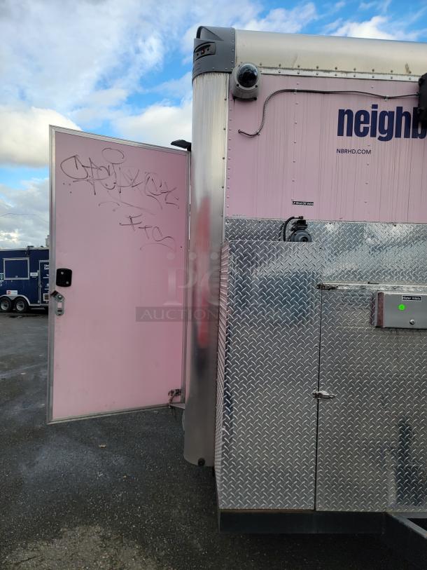 2021 16' REEF/NBRHD mobile kitchen trailer, pink exterior with diamond-plate finish, security camera, graffiti on open door.