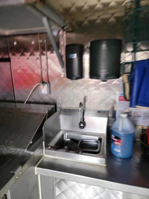 2021 16' REEF/NBRHD mobile kitchen with a hand-washing sink, soap dispenser, and diamond-plate walls. Perfect for high-volume use.