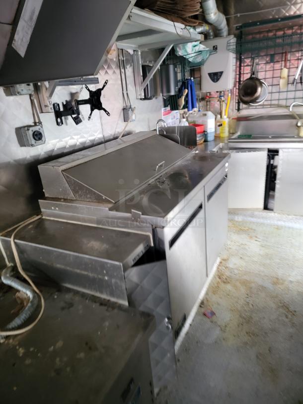 2021 16' REEF/NBRHD mobile kitchen interior showing Arctic Air refrigeration units, sinks, and stainless steel counters.