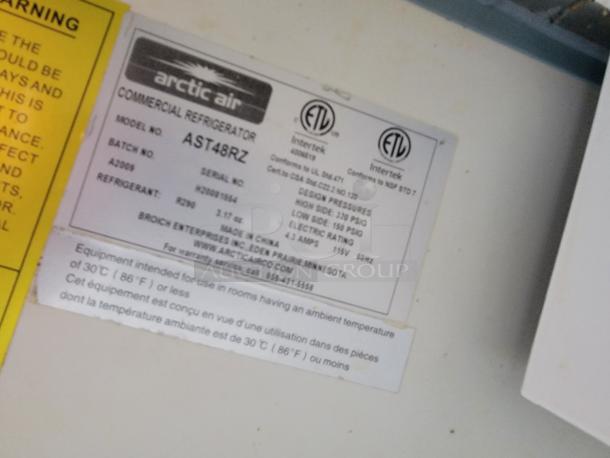 Label on Arctic Air commercial refrigerator model AST48RZ, includes serial number, refrigerant type, and electrical rating details.