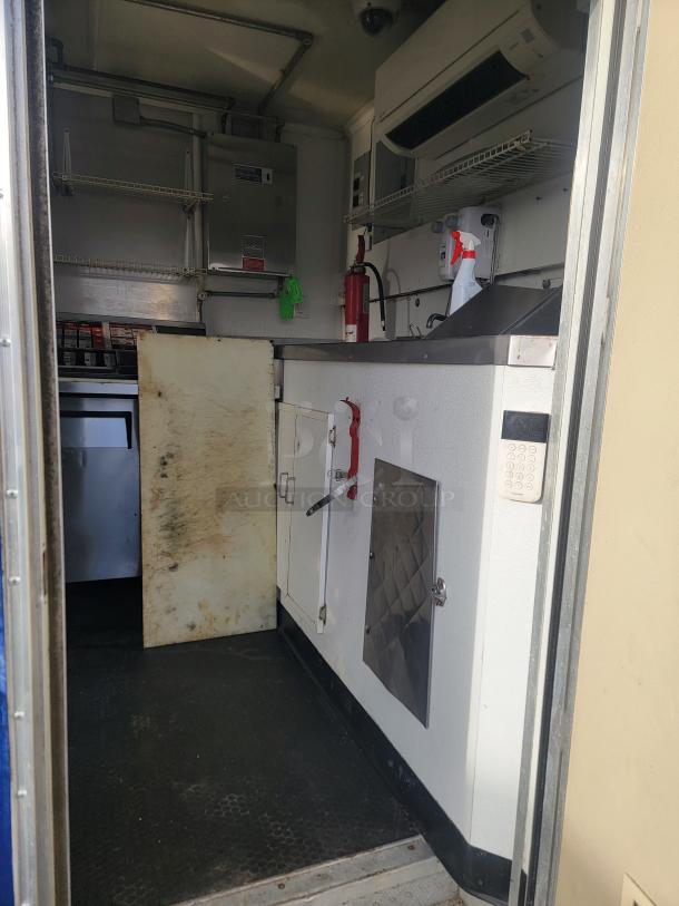 2019 Diamond Cargo 16' ghost kitchen trailer interior, showing stainless steel surfaces, fire extinguisher, and HVAC unit.