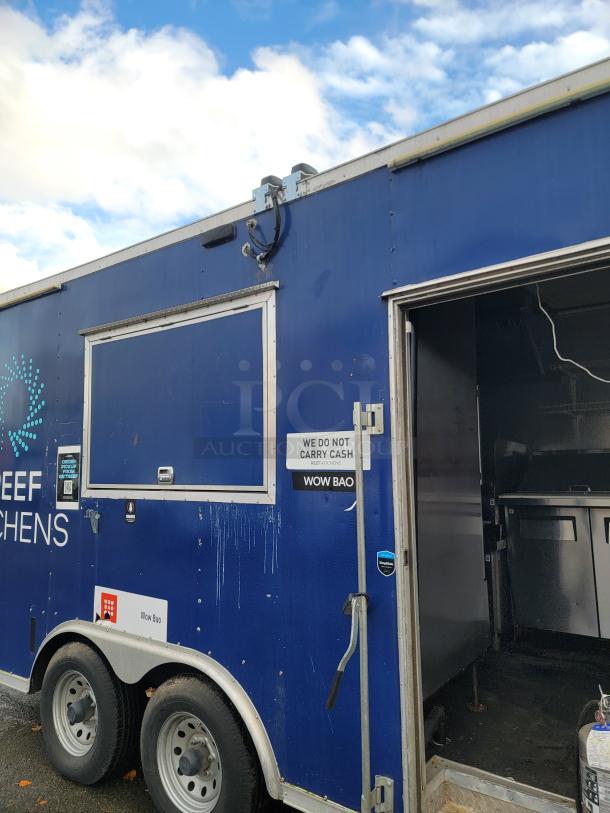 2019 Diamond Cargo 16' food trailer, blue exterior, tandem-axle, side service window, open door showing interior kitchen equipment.