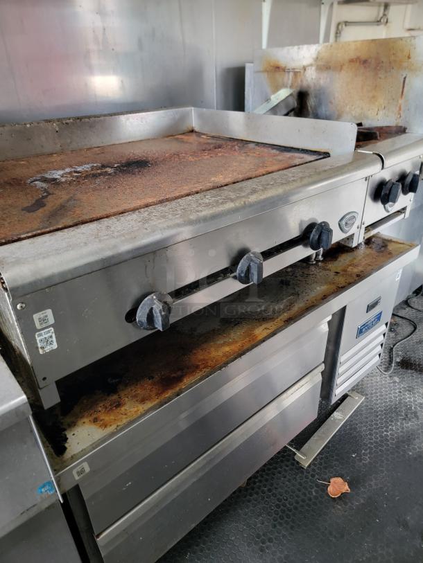 2019 Diamond Cargo food trailer with Wells griddle and Pitco fryer. Features commercial hood and used condition.