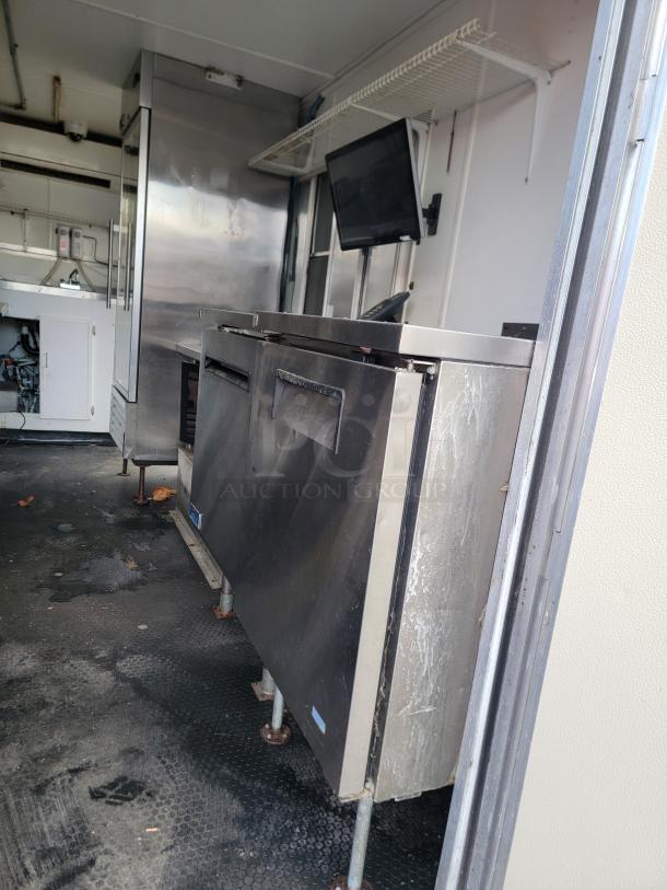Turnkey 2019 Diamond Cargo 16' food trailer interior, showcasing stainless steel prep equipment, multi-basin sink, and refrigeration units.