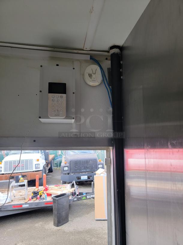 2019 Diamond Cargo food trailer interior with keypad and smoke detector, part of a turnkey setup with modern equipment.