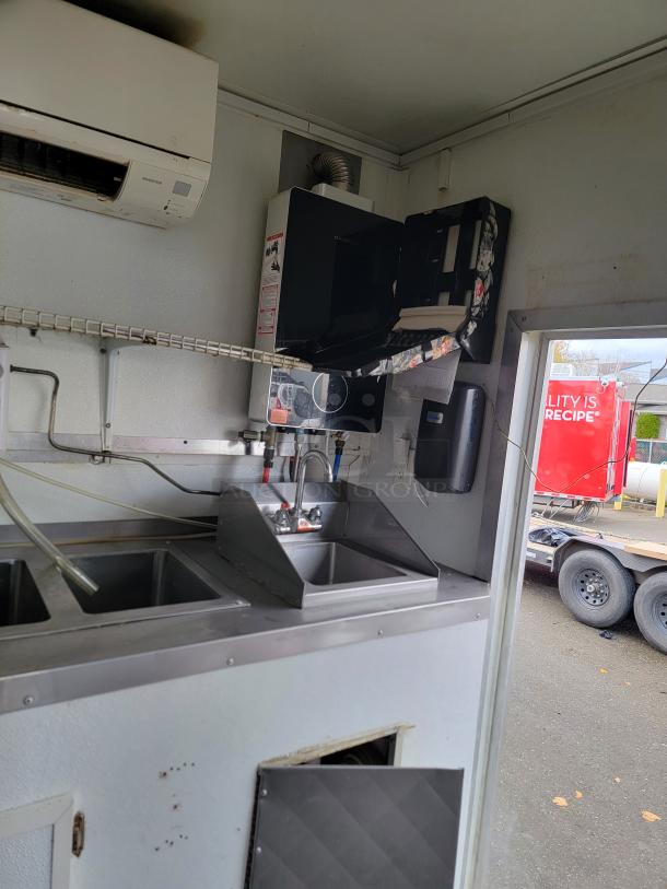 2019 Diamond Cargo 16' food trailer interior with multi-basin sink, water heater, HVAC unit. Ready for turnkey operation.