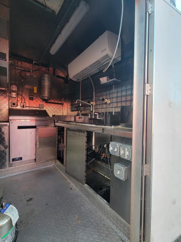 2020 Diamond Cargo 16' food trailer interior, equipped with commercial appliances, sink, and electrical outlets.