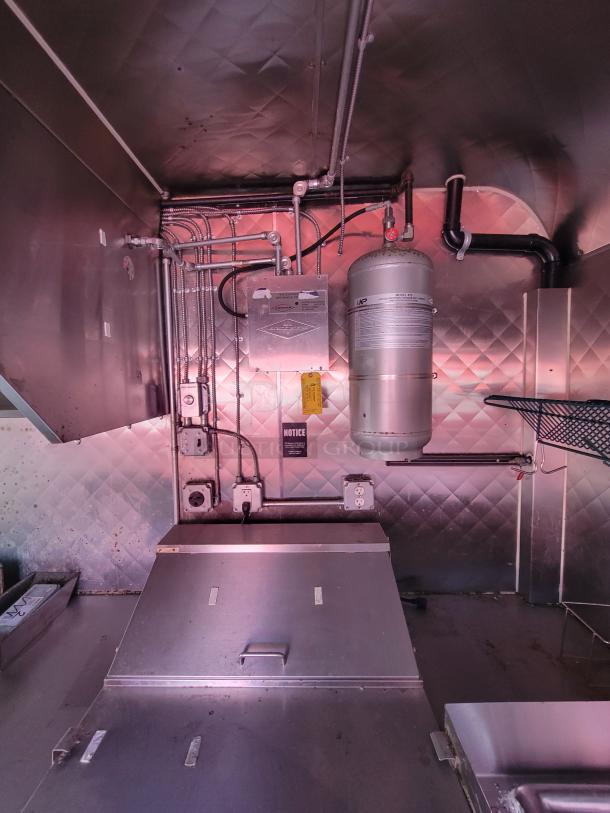 2020 Diamond Cargo 16' food trailer interior with gas setup and electrical system. Stainless steel finish, ready for use.