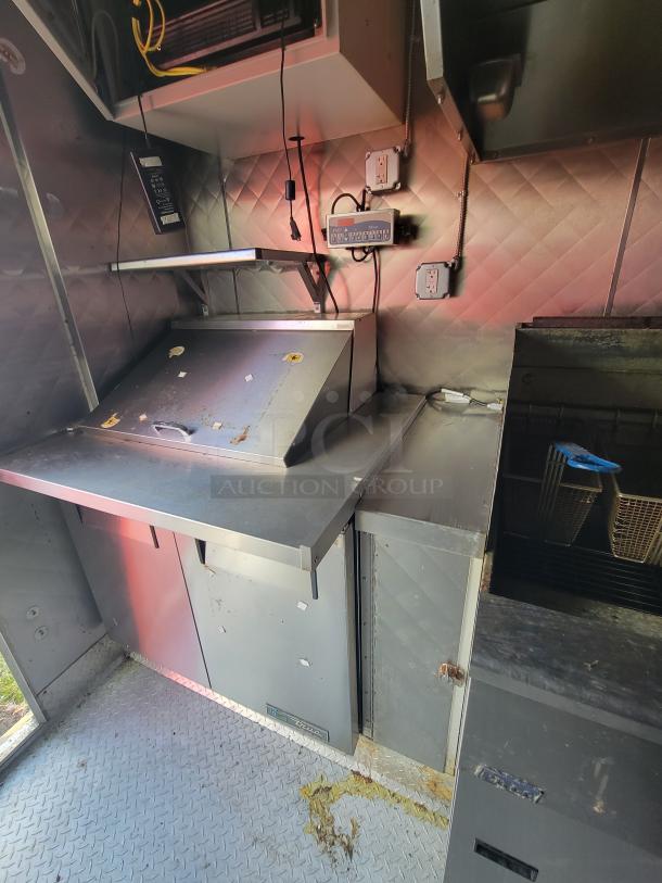 2020 Diamond Cargo 16' food trailer interior, featuring stainless steel commercial kitchen setup, appliances, and electrical outlets.