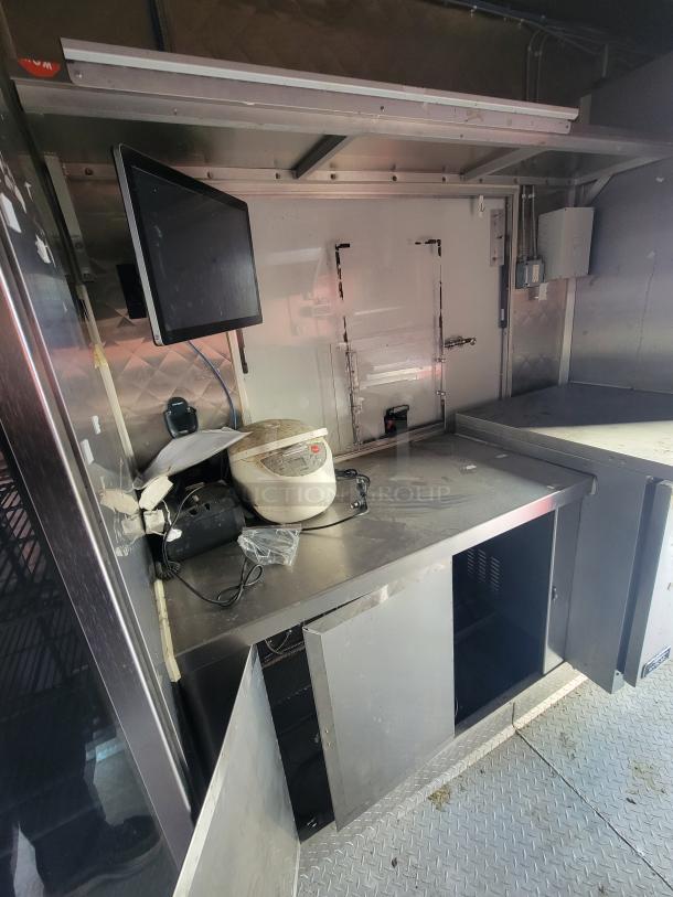 2020 Diamond Cargo 16' food trailer interior with commercial appliances, stainless steel counters, and storage. Ready for use.
