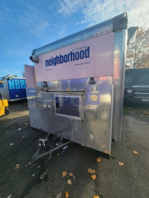 2020 16' Quality mobile kitchen trailer with stainless steel and diamond-plate exterior. Signage reads "Neighborhood Kitchens."