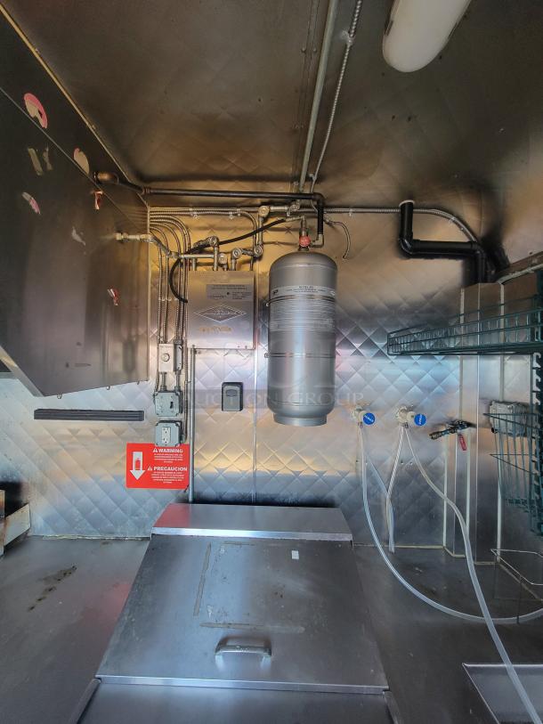 2020 16' Quality Mobile Kitchen interior, showing stainless steel walls, commercial hood, and fire suppression system.