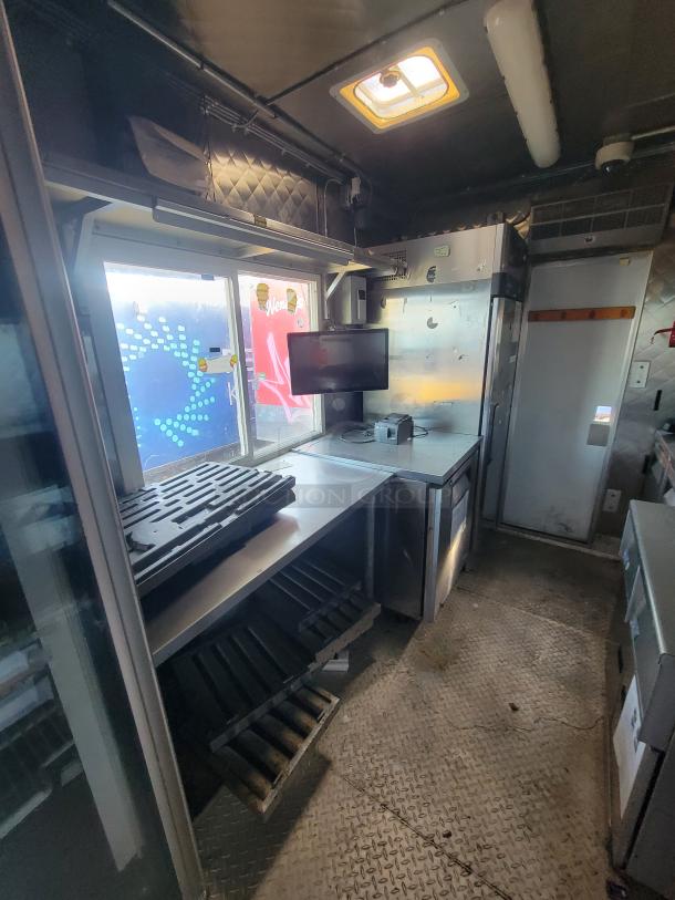 2020 Quality 16' Food Trailer interior; stainless steel walls, diamond-plate flooring, Turbo Air refrigeration, prep area.