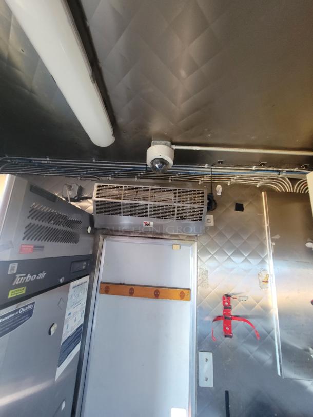 2020 16' Quality Mobile Kitchen interior with Turbo air units, stainless steel walls, and diamond-plate flooring.