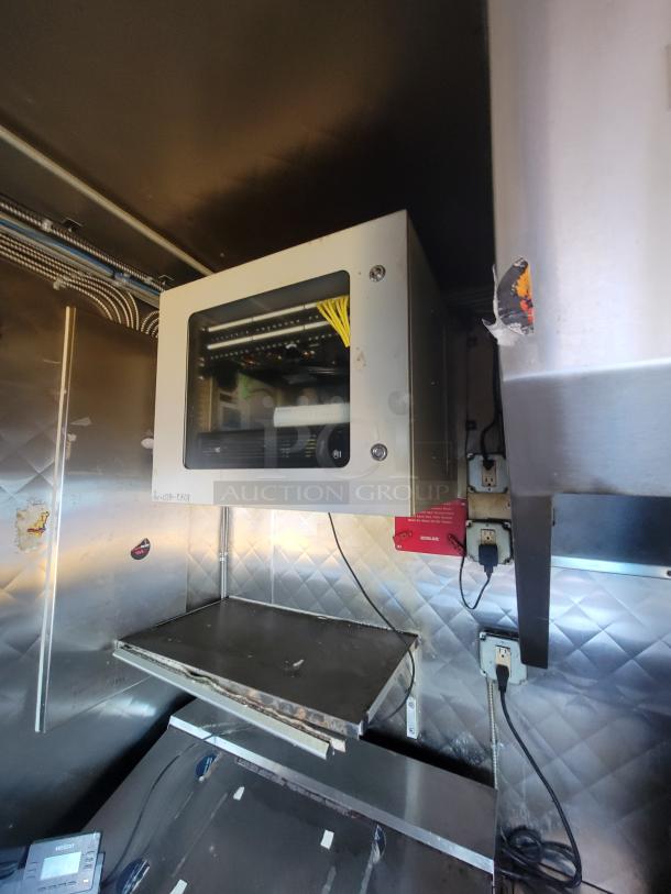 2020 Quality 16' mobile kitchen interior with stainless steel walls, wiring, and metal shelves. Includes electrical outlets.